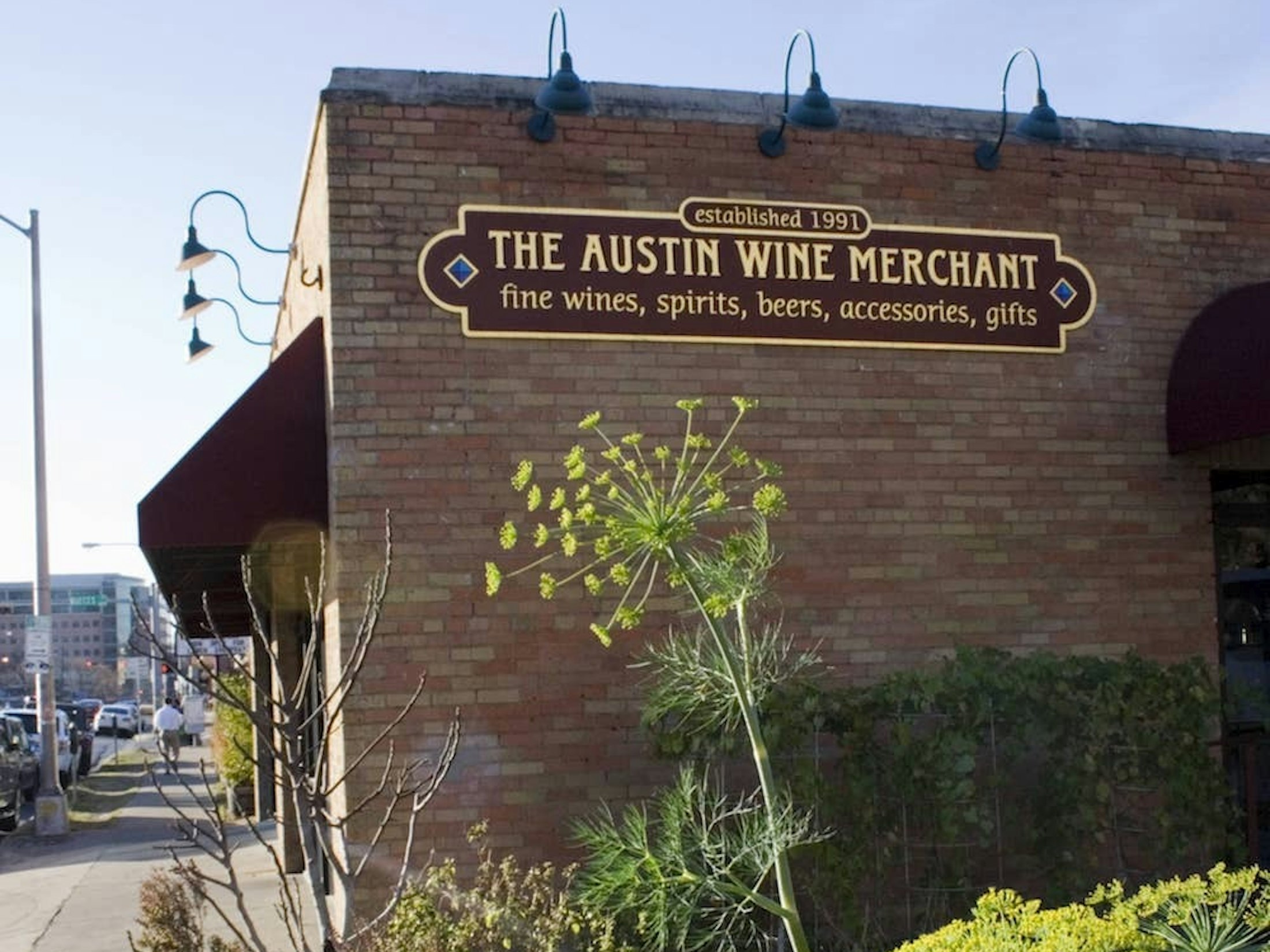 side of a brick building with a sign that reads the Austin Wine Merchant.