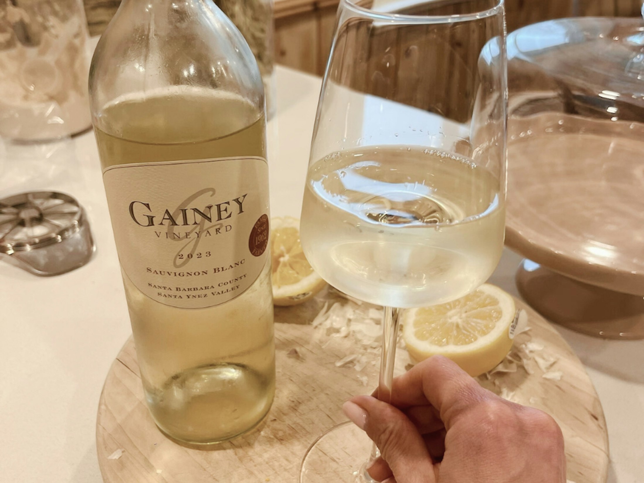 bottle of white wine next to a glass of white wine