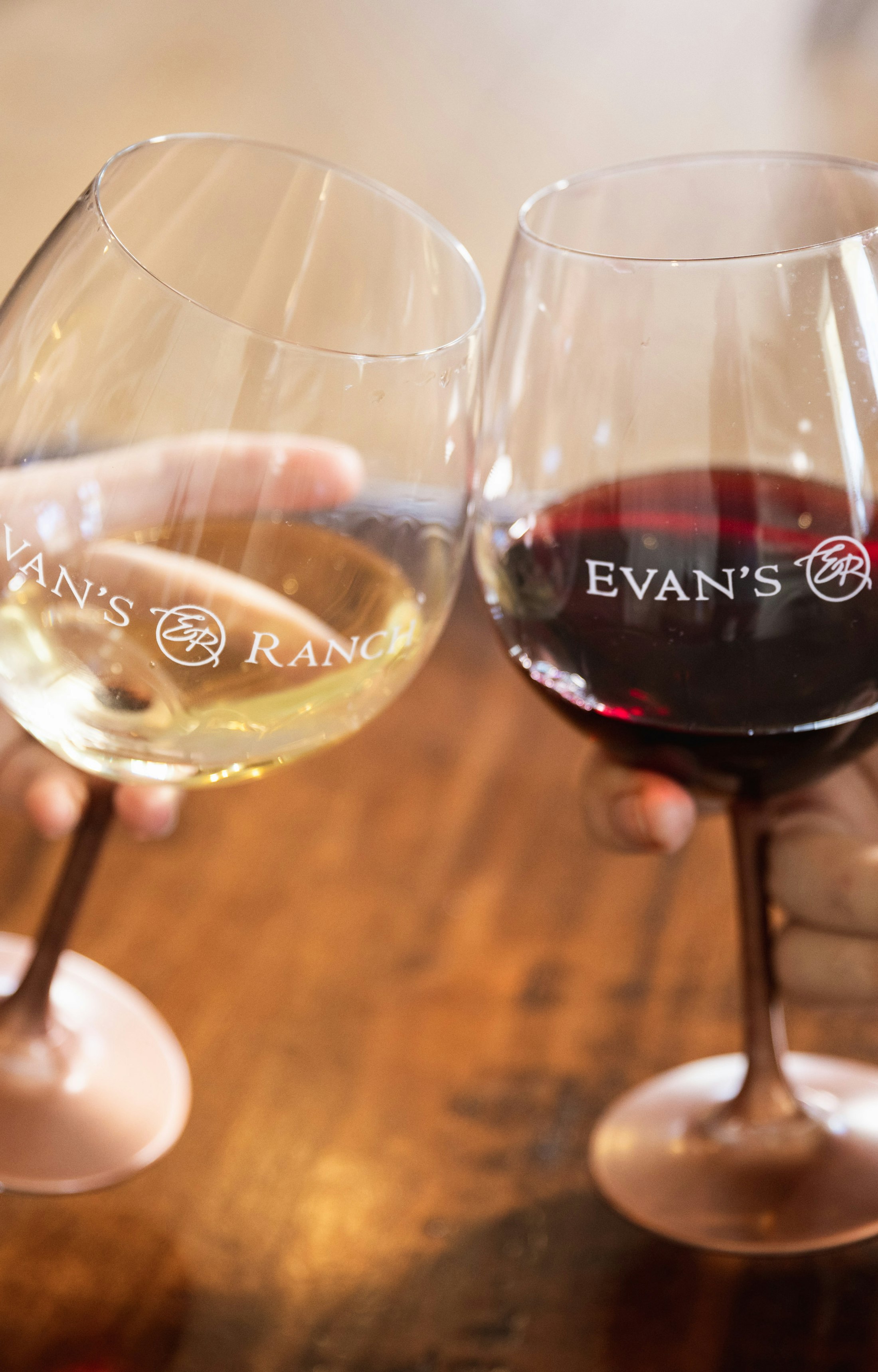 Evan's Ranch wine glasses filled white and red wine