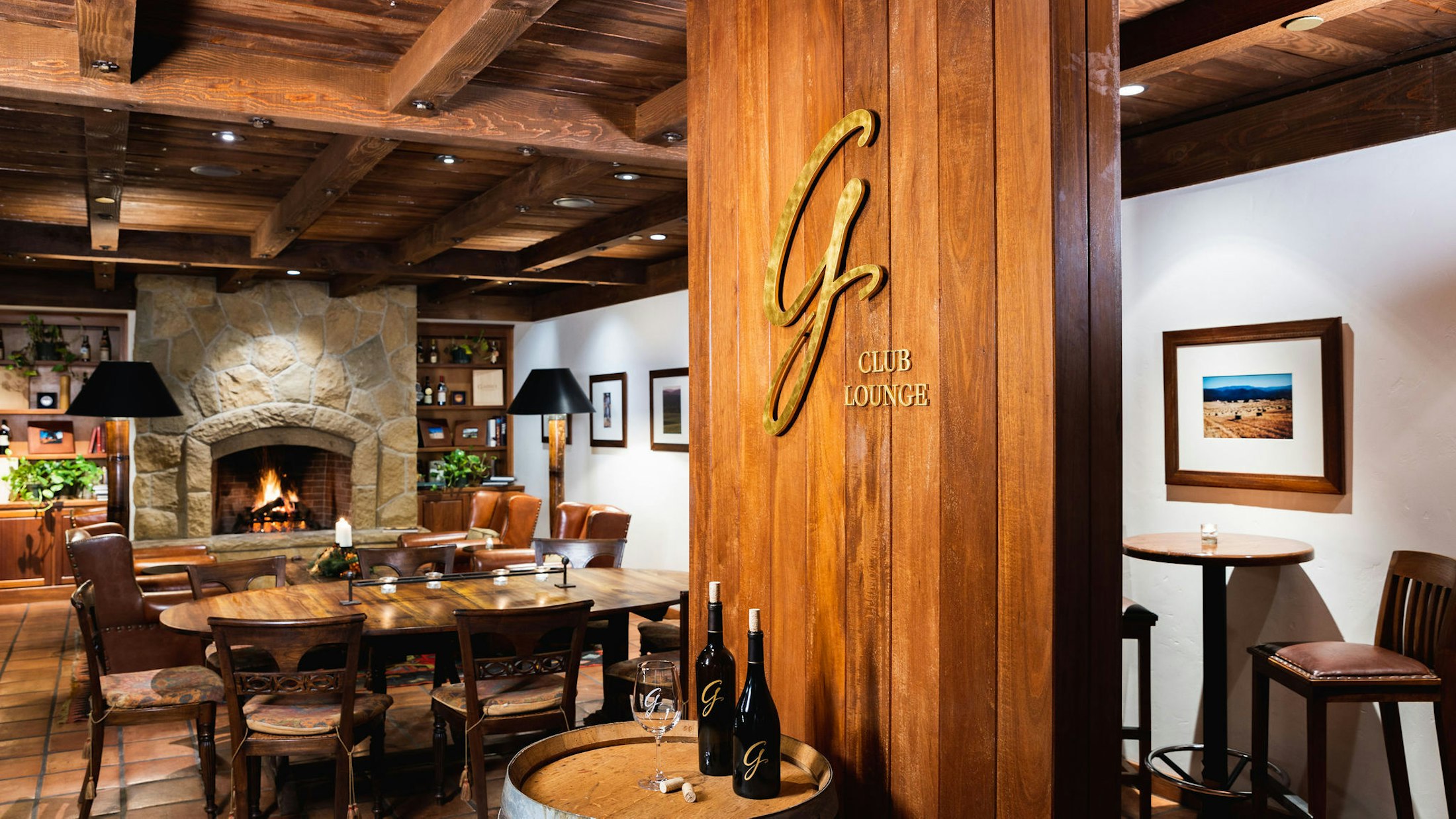 The Gainey club lounge, a cozy room ranch style with a lit fireplace.