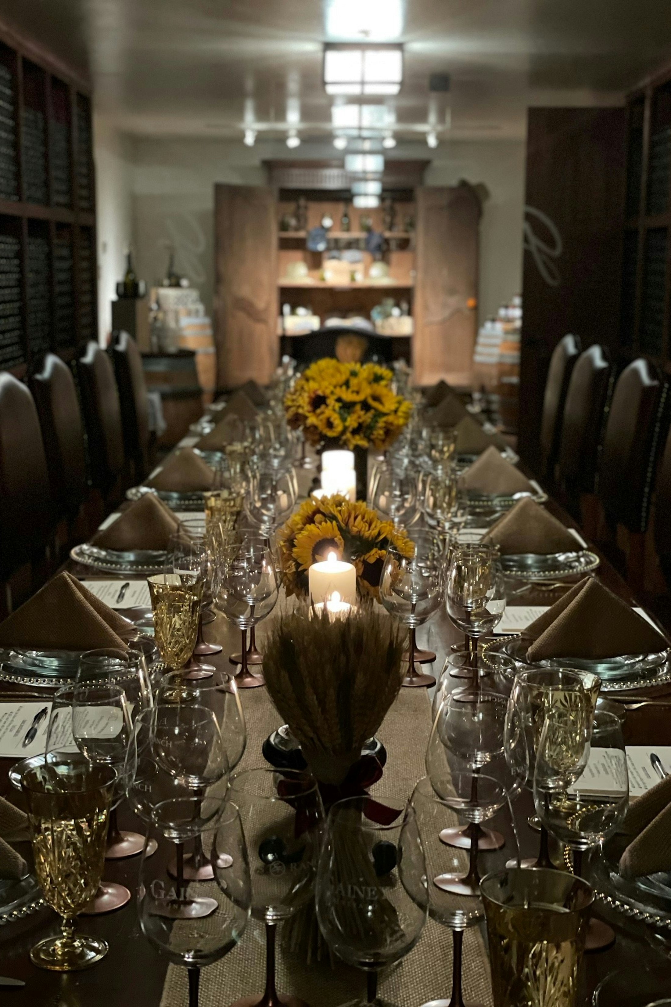 A long table in the cellar room set with sunflowers