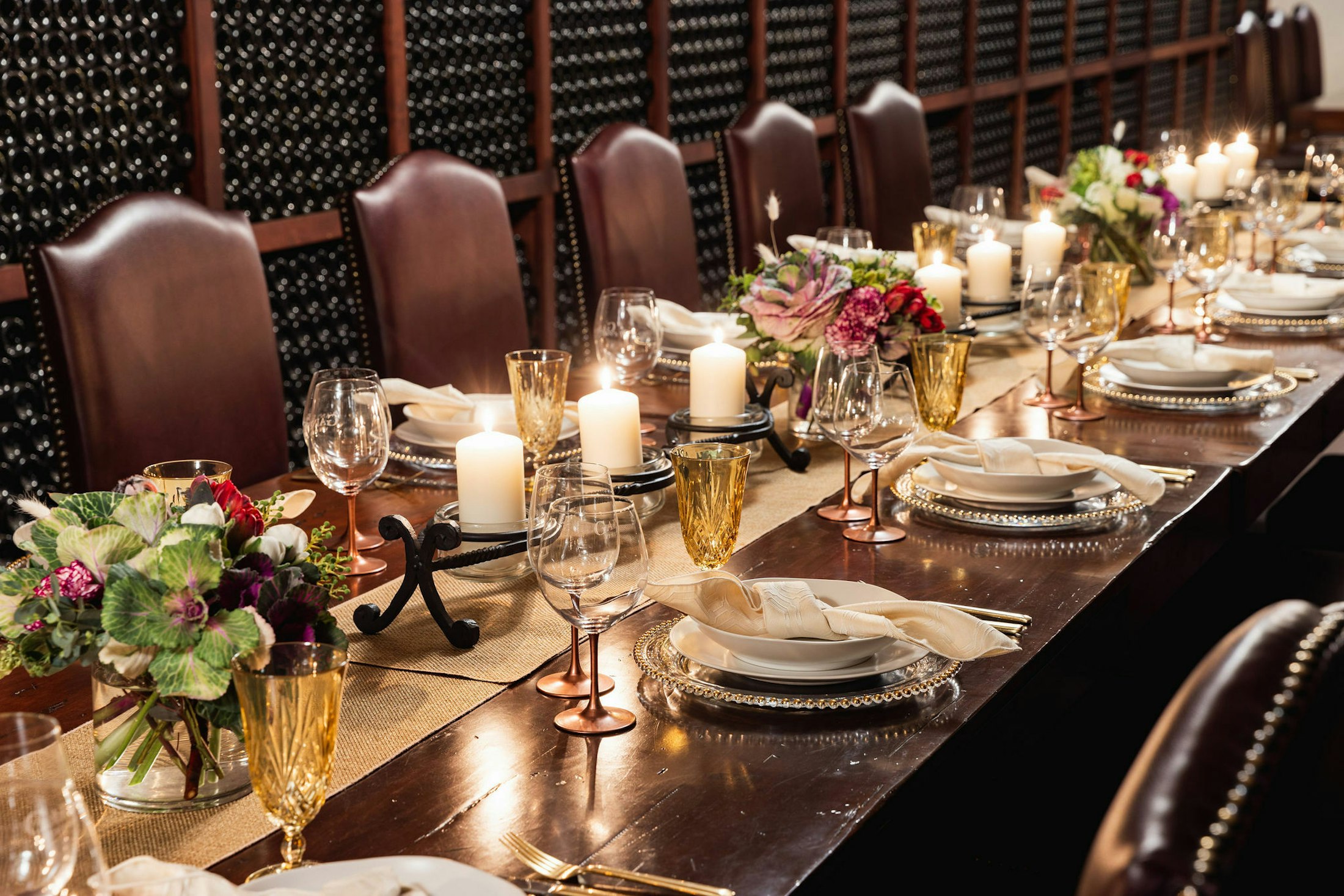 Close up of a long dining table set up