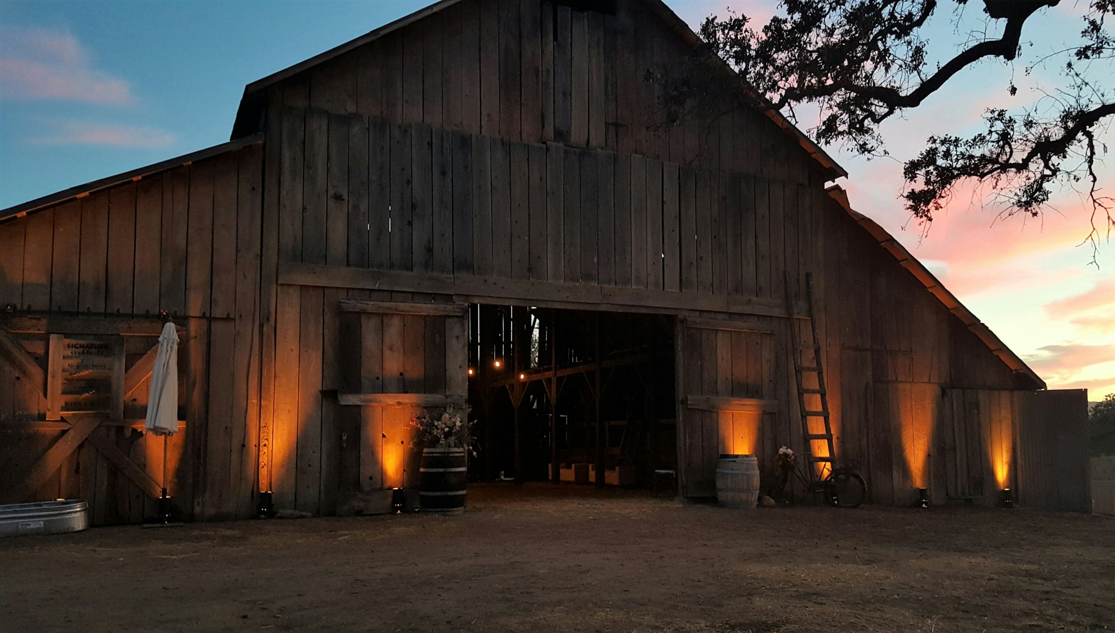 The historic barn lit from the bottom at dusk